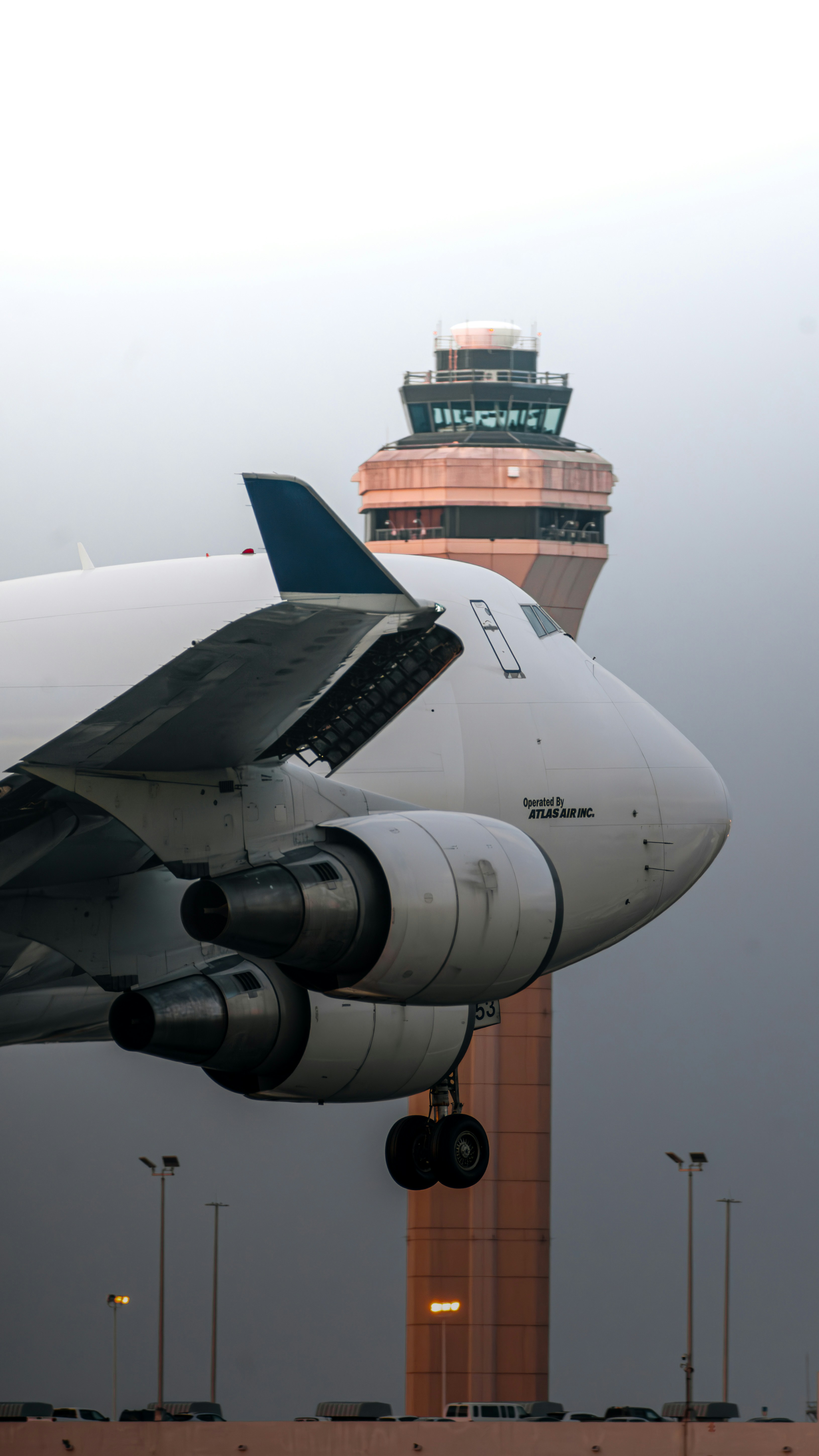 Atlas Air cargo aircraft on a runway with an air traffic control tower in the background
