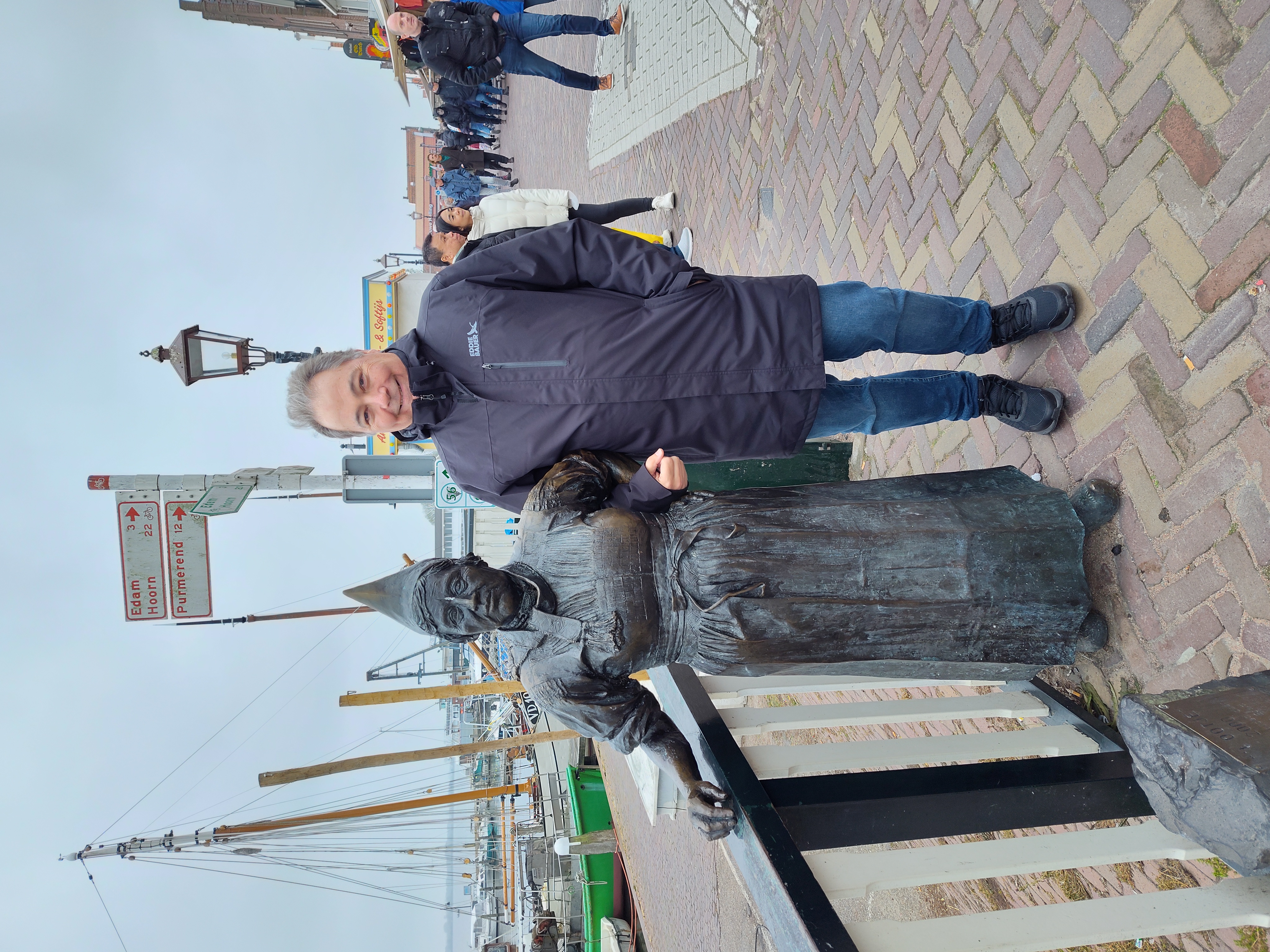 Jean-François D'Arcy smiling beside a statue in Volendam, Netherlands
